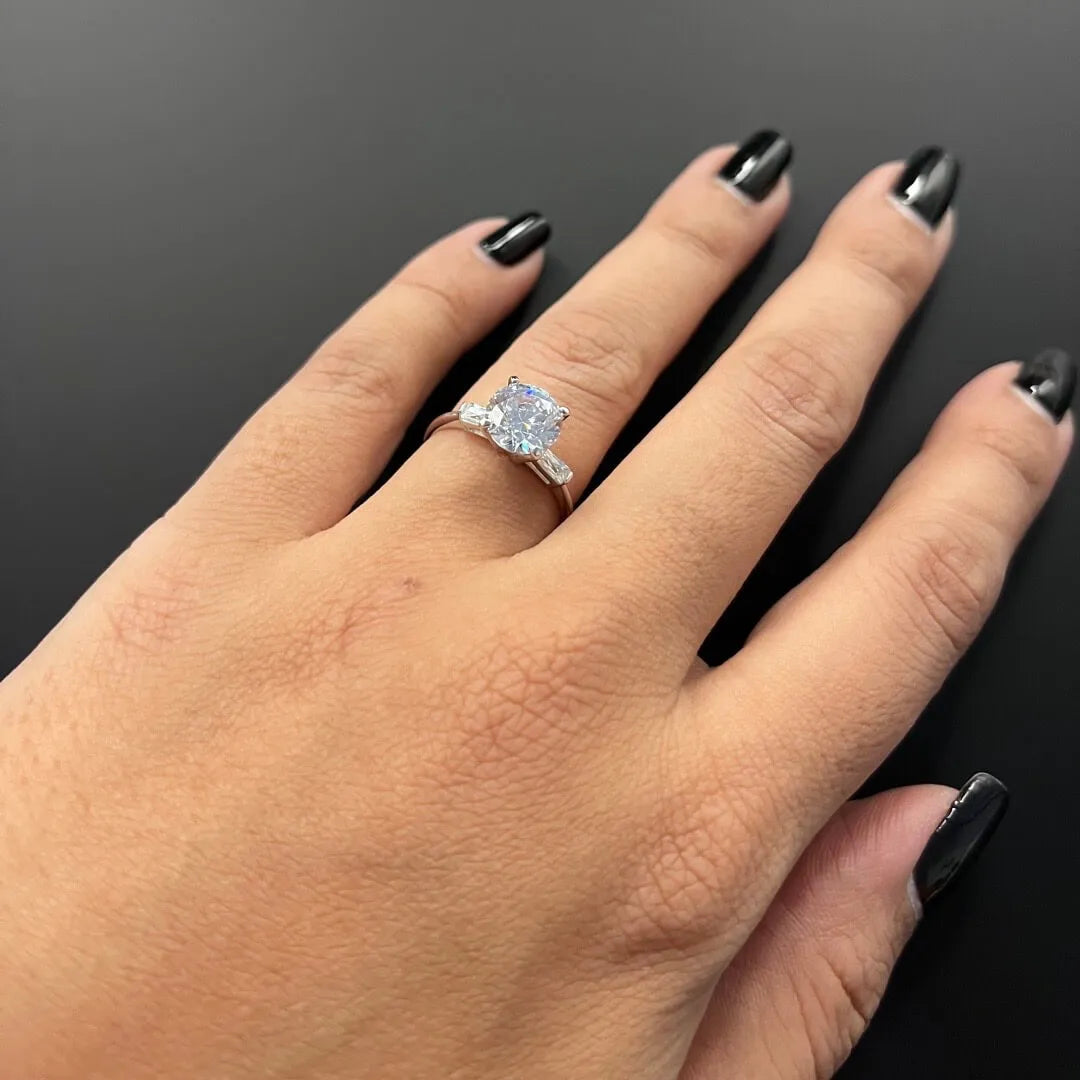 2 CARAT SOLITAIRE FLANKED BY BAGUETTE DIAMONDS WITH PLAIN BAND