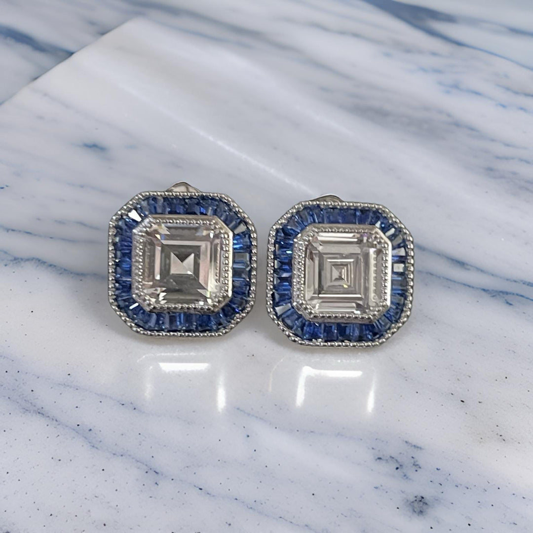 ASSCHER CUT DIAMOND WITH BLUE BAGUETTE HALO STUD