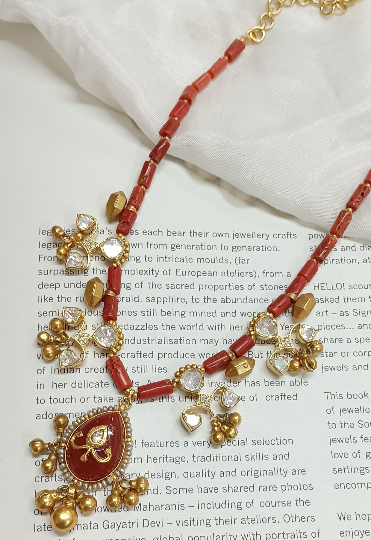 The Golden Eye: Coral Bead and Gold Charm Necklace
